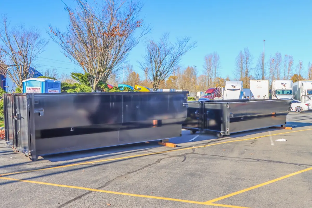 Professional dumpster rental service with roll-off container on residential driveway in Appleton